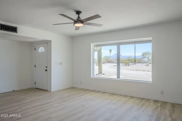 wooden floor in an empty room with a window