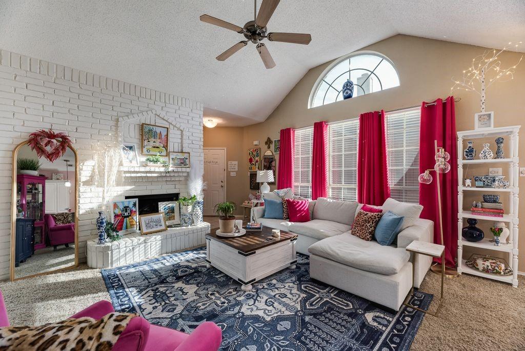 3205 Cape Cod Court Arlington, TX 76017 - Photo 7 of 30 a living room with furniture a rug and a fireplace