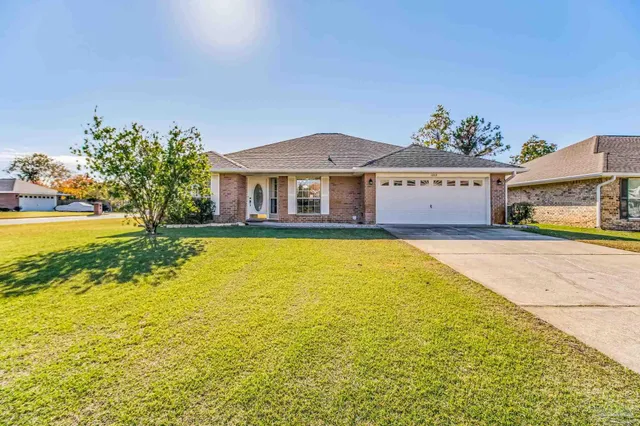 a front view of a house with yard and swimming pool