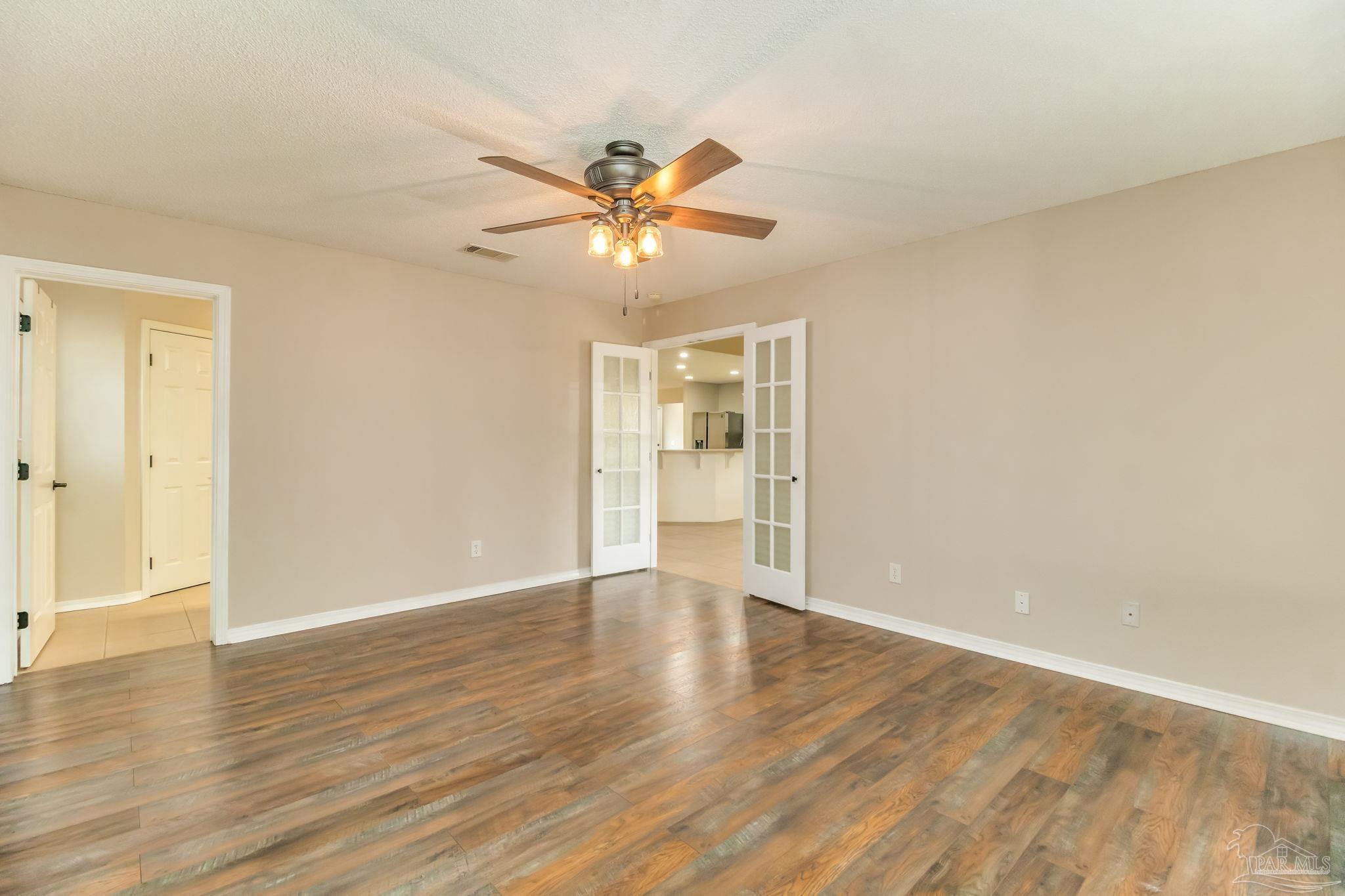 1225 Grand Ridge Circle Gulf Breeze, FL 32563 - Photo 14 of 29 a view of an empty room with window and wooden floor