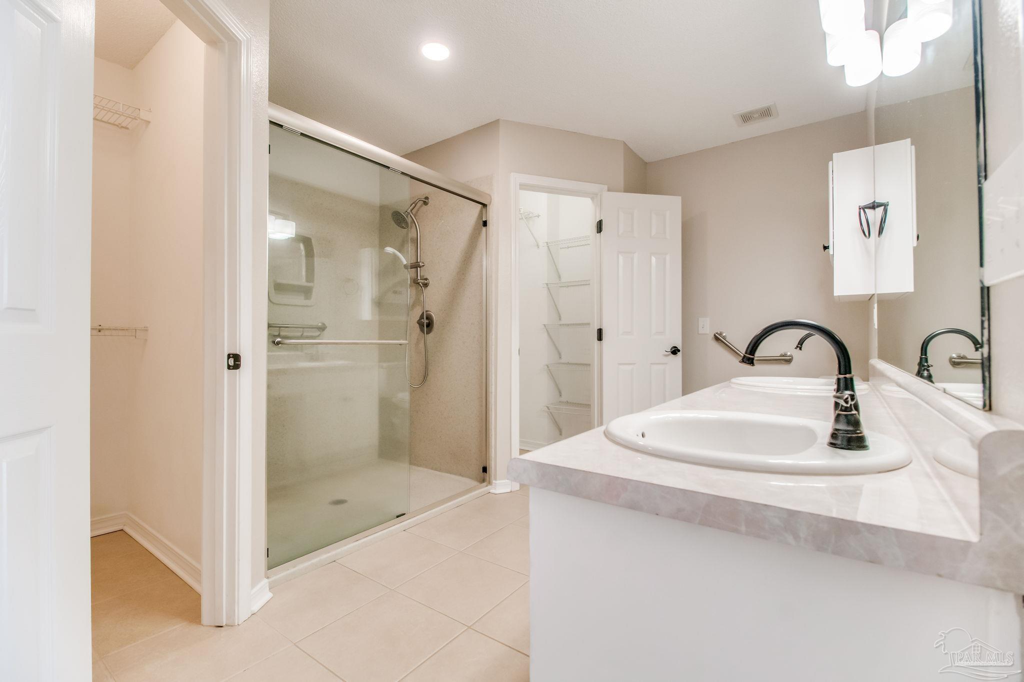 1225 Grand Ridge Circle Gulf Breeze, FL 32563 - Photo 15 of 29 a bathroom with a sink and a shower