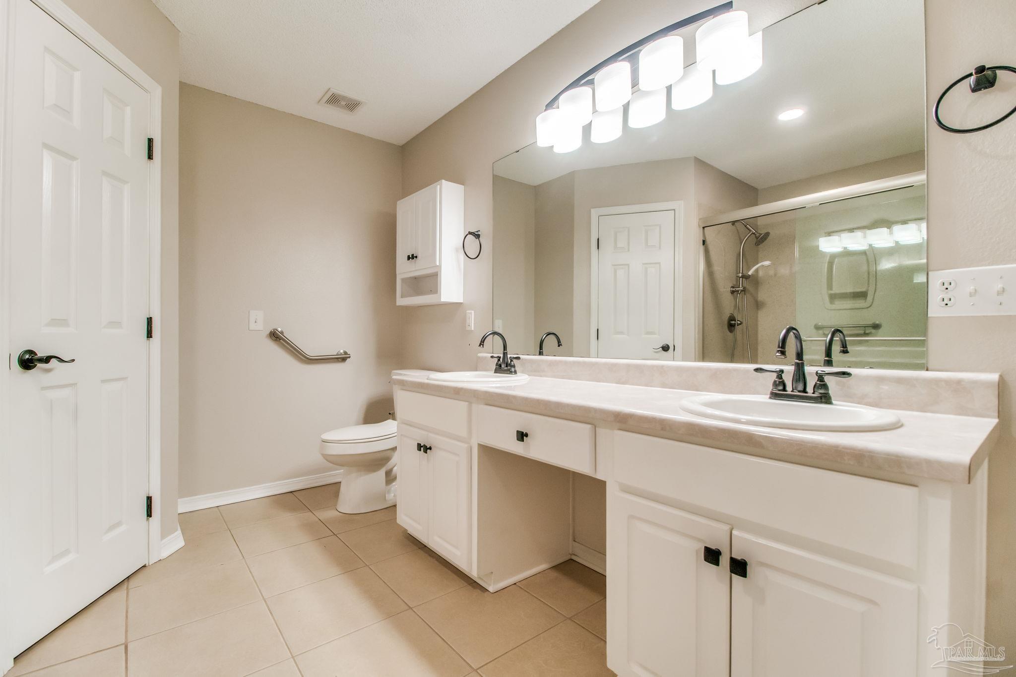 1225 Grand Ridge Circle Gulf Breeze, FL 32563 - Photo 17 of 29 a spacious bathroom with a double vanity sink mirror and toilet