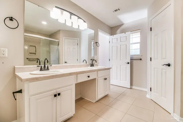 a spacious bathroom with a double vanity sink mirror and double