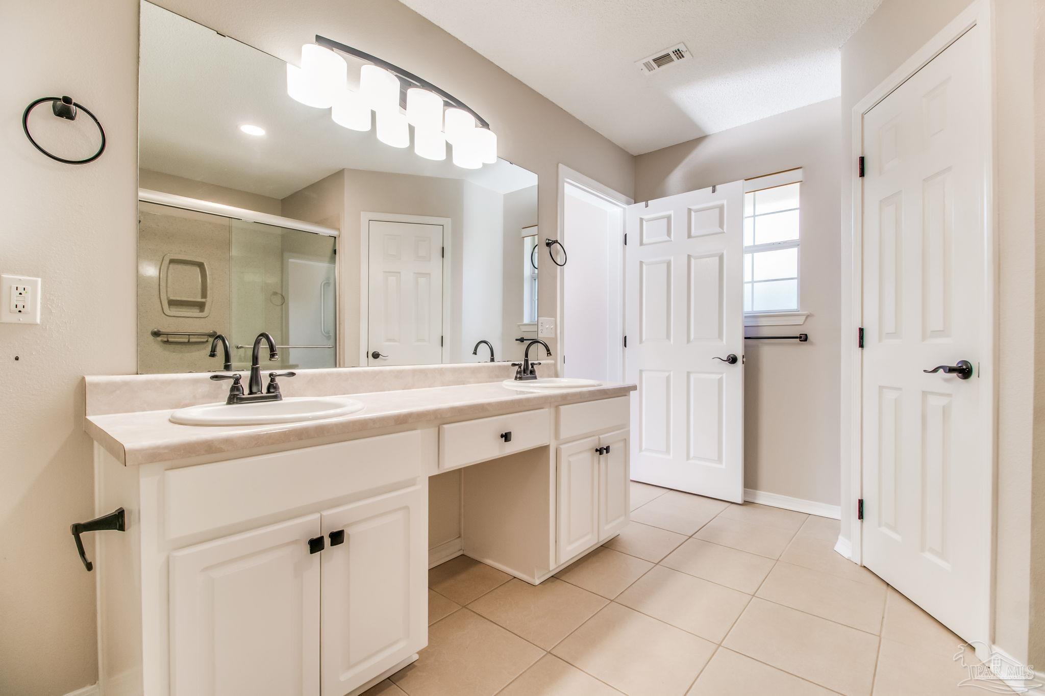 1225 Grand Ridge Circle Gulf Breeze, FL 32563 - Photo 18 of 29 a spacious bathroom with a double vanity sink mirror and double