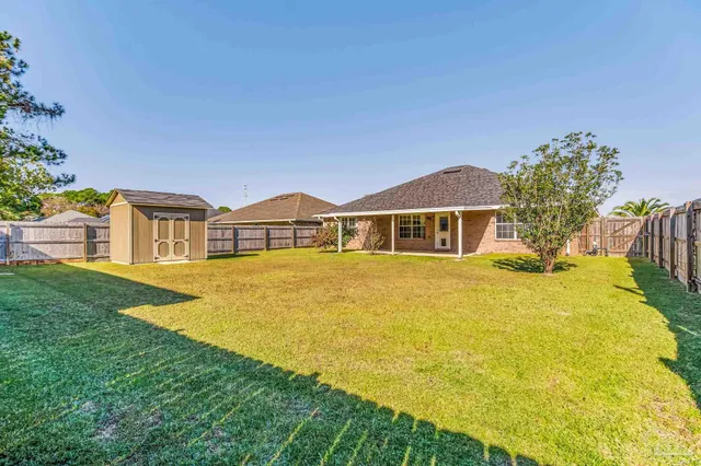 a front view of a house with yard and swimming pool