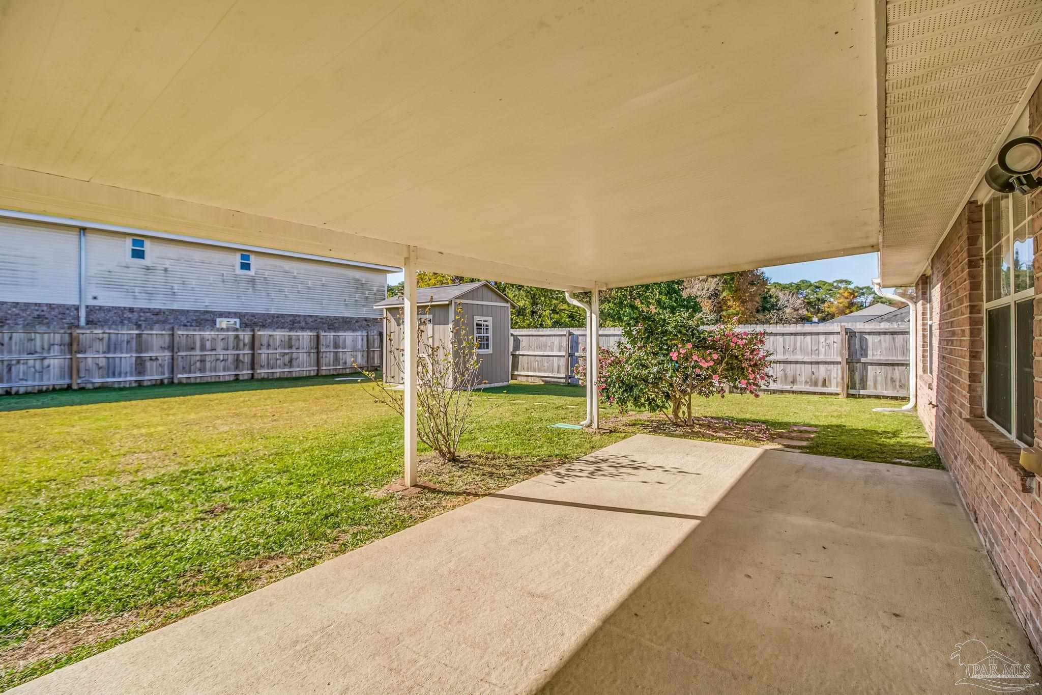 1225 Grand Ridge Circle Gulf Breeze, FL 32563 - Photo 26 of 29 a view of a swimming pool with a yard