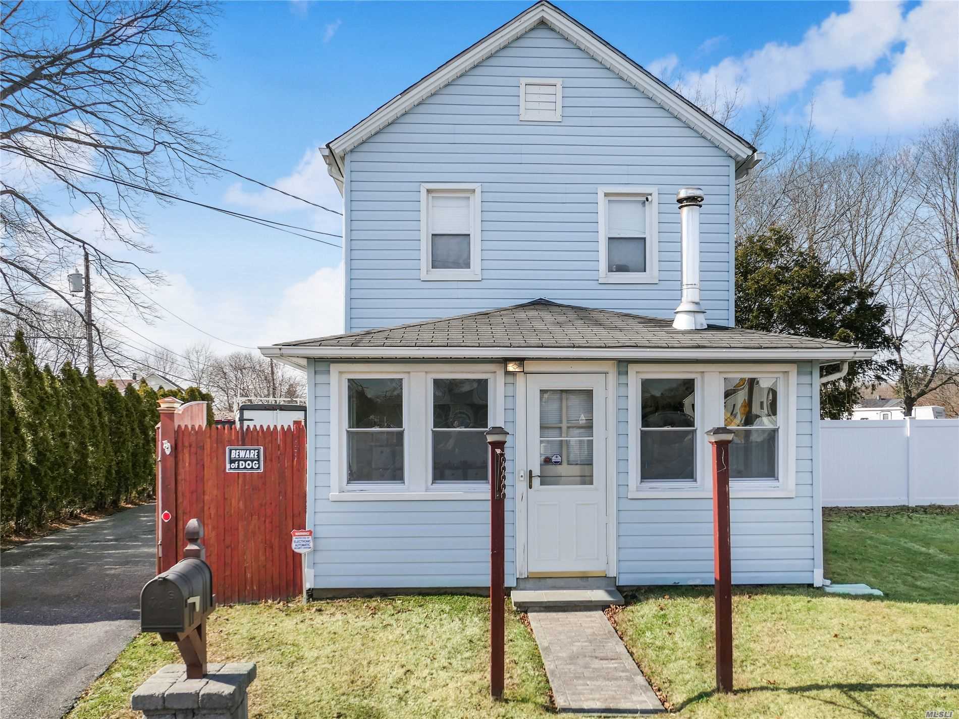58 Fuoco Road Bellport, NY 11713 - Photo 1 of 1 a front view of a house with a garden