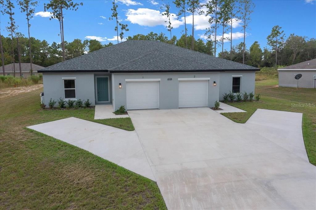 6139 Southwest 143rd Street Ocala, FL 34473 - Photo 1 of 1 a front view of a house with yard and outdoor seating