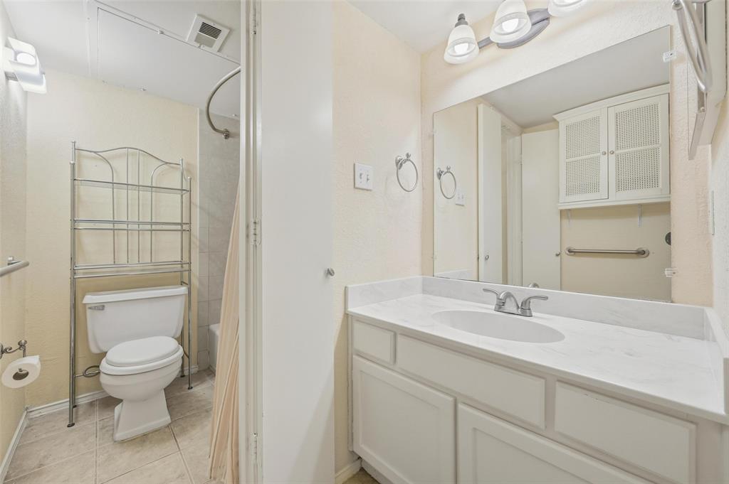 2311 Basil Drive, Unit C105 Arlington, TX 76006 - Photo 13 of 17 Full bathroom with vanity, light tile patterned floors, and shower / bath combination with curtain