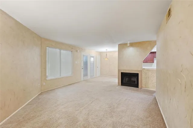 a view of an empty room with a fireplace