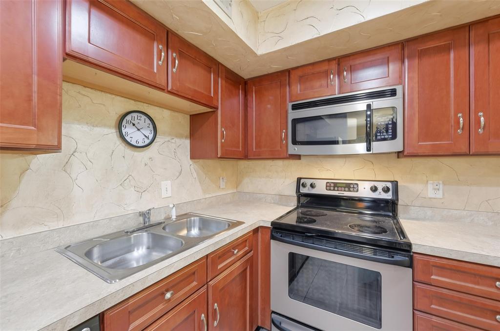 2311 Basil Drive, Unit C105 Arlington, TX 76006 - Photo 8 of 17 Kitchen featuring stainless steel appliances, tasteful backsplash, and light countertops