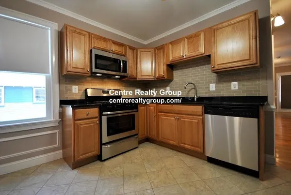a kitchen with stainless steel appliances granite countertop a stove a microwave and a sink