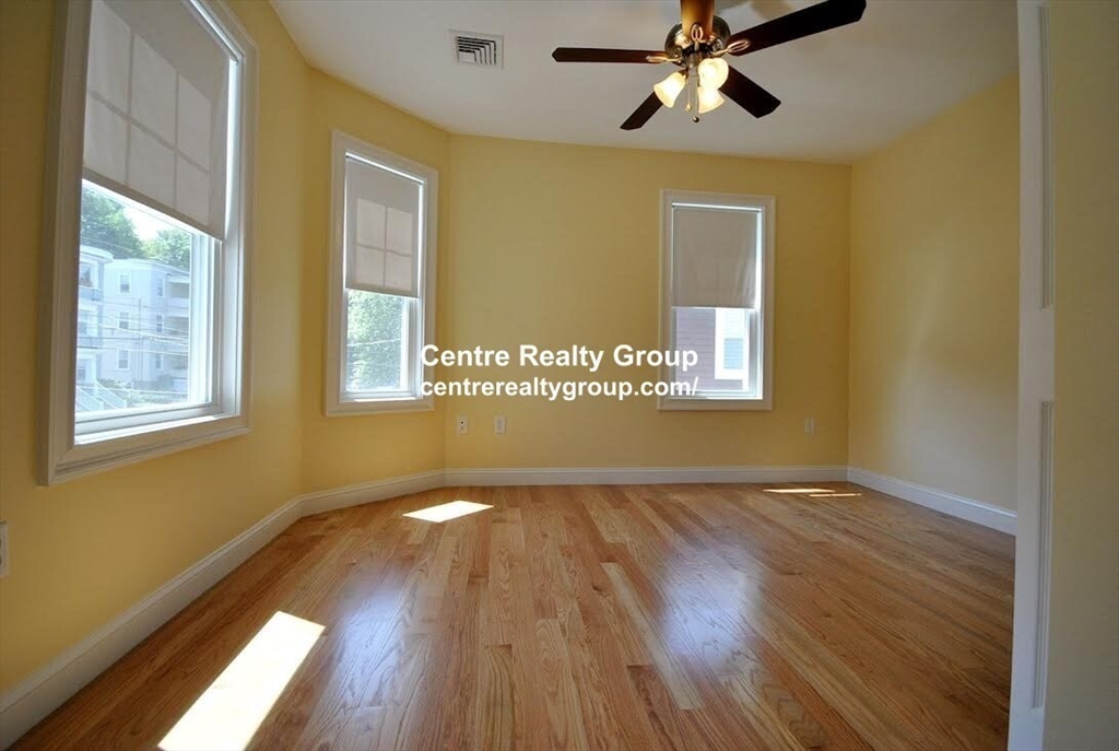38-40 Turner Street, Unit 2 Boston, MA 02135 - Photo 3 of 6 a view of an empty room with a window and wooden floor