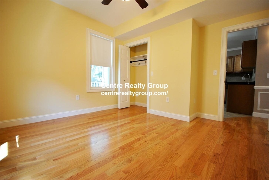 38-40 Turner Street, Unit 2 Boston, MA 02135 - Photo 4 of 6 a view of an empty room with wooden floor and a window