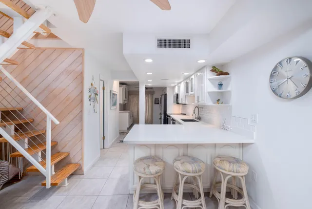 a large kitchen with a table and chairs