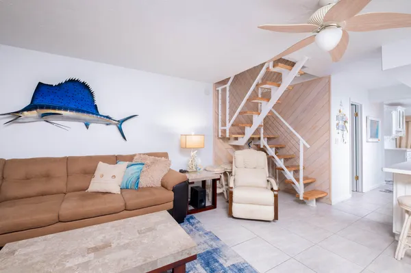 a living room with furniture and stairs