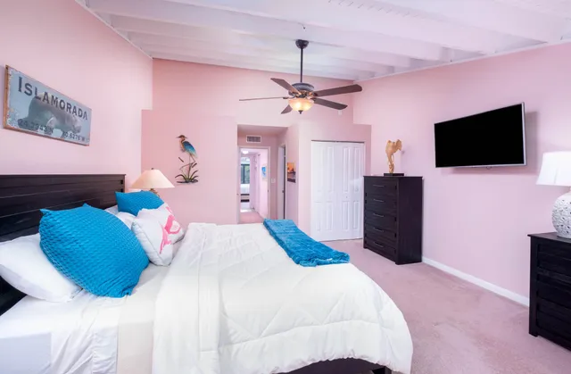 a bedroom with a bed and a flat screen tv