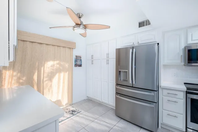 a kitchen with stainless steel appliances a refrigerator and a stove