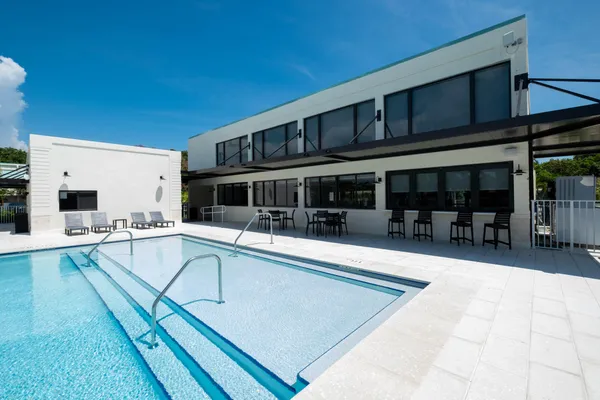 a view of a house with swimming pool and sitting area