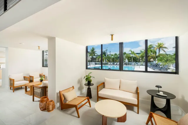 a living room with furniture and a floor to ceiling window