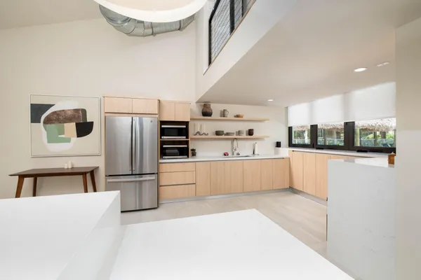a kitchen with stainless steel appliances a refrigerator and a stove