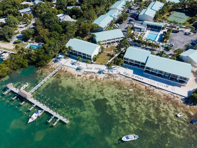 an aerial view of a house with a yard and lake view