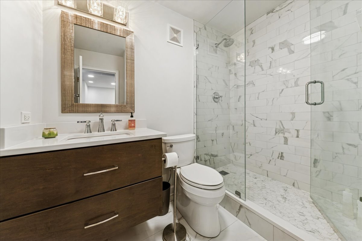 111 East Chestnut Street, Unit 22K Chicago, IL 60611 - Photo 11 of 20 a bathroom with a sink a toilet and shower