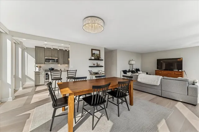 a view of a dining room with furniture and a flat screen tv