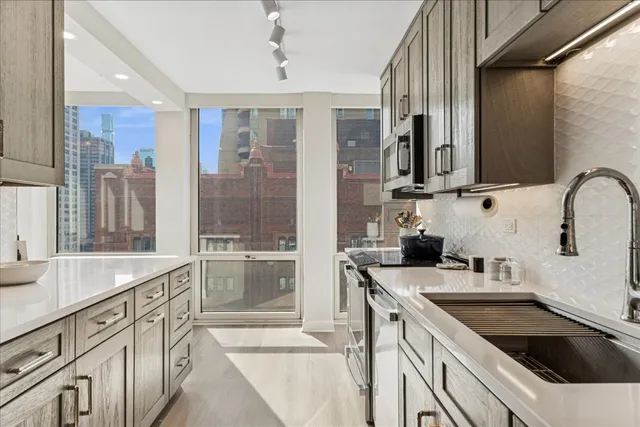 a kitchen with a sink stove and cabinets