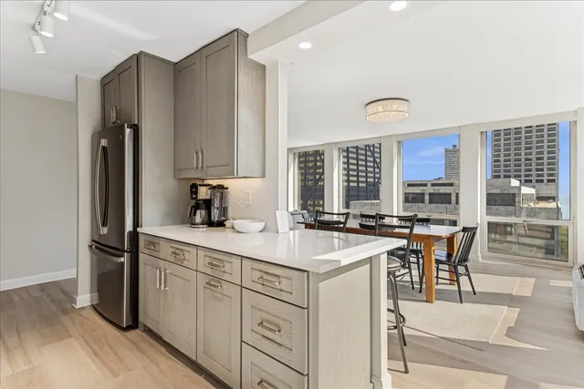 a kitchen with a sink stove and chairs