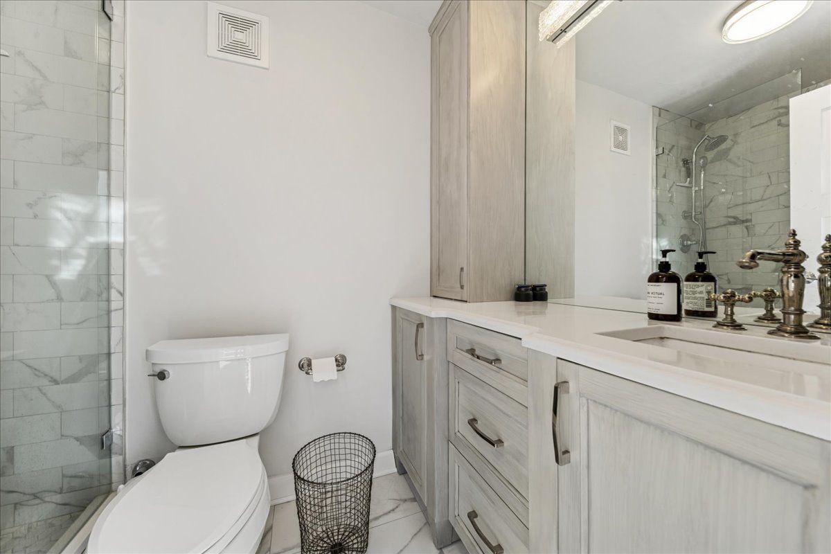 111 East Chestnut Street, Unit 22K Chicago, IL 60611 - Photo 7 of 20 a bathroom with a toilet sink and mirror