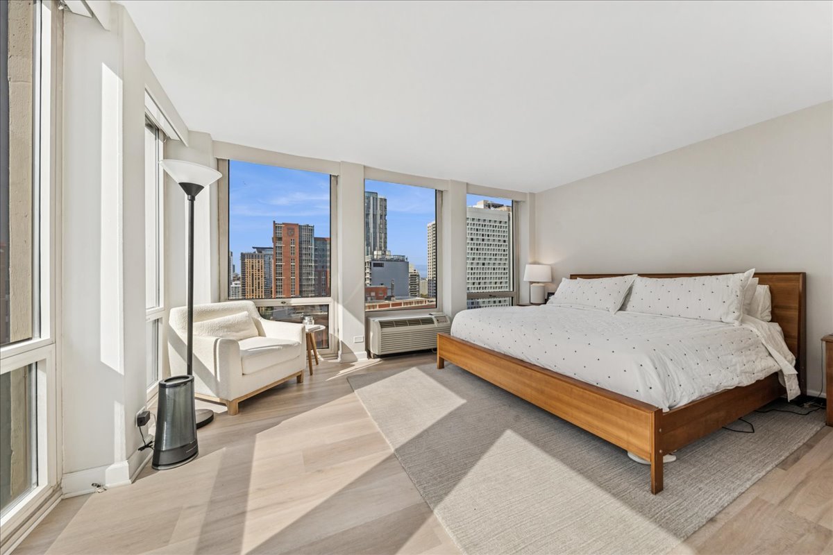 111 East Chestnut Street, Unit 22K Chicago, IL 60611 - Photo 8 of 20 a bedroom with a large bed and a large window