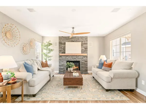 a living room with furniture a fireplace and a table