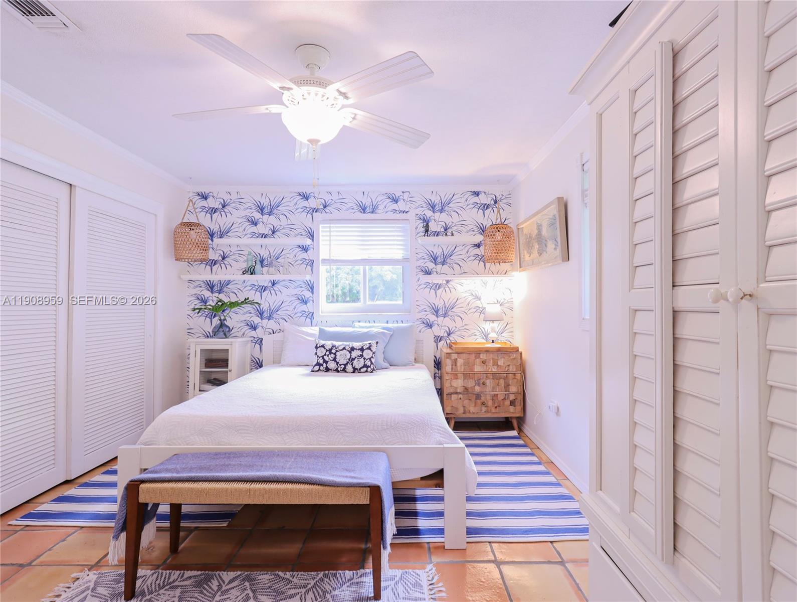 160 Ridge Street Tavernier, FL 33070 - Photo 12 of 24 a bedroom with a bed and a table with potted plant