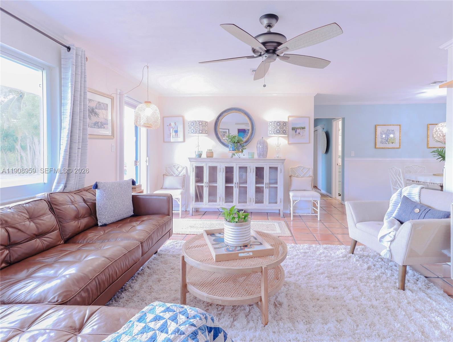 160 Ridge Street Tavernier, FL 33070 - Photo 3 of 24 a living room with furniture a large window and a chandelier