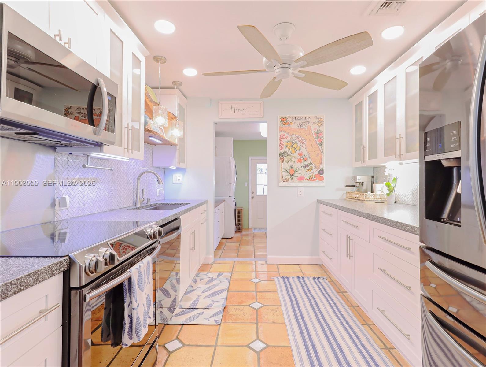 160 Ridge Street Tavernier, FL 33070 - Photo 6 of 24 a kitchen with stainless steel appliances granite countertop a stove and a sink