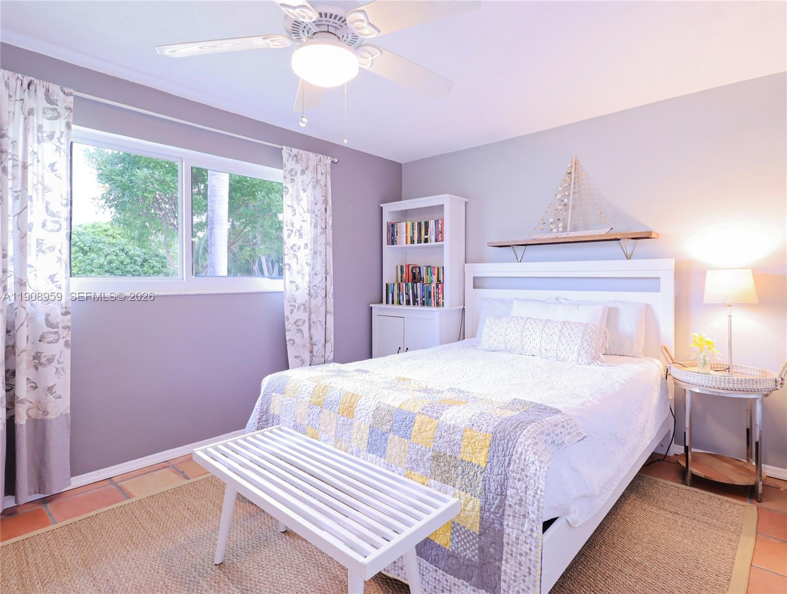160 Ridge Street Tavernier, FL 33070 - Photo 10 of 24 a bedroom with a bed and a chandelier