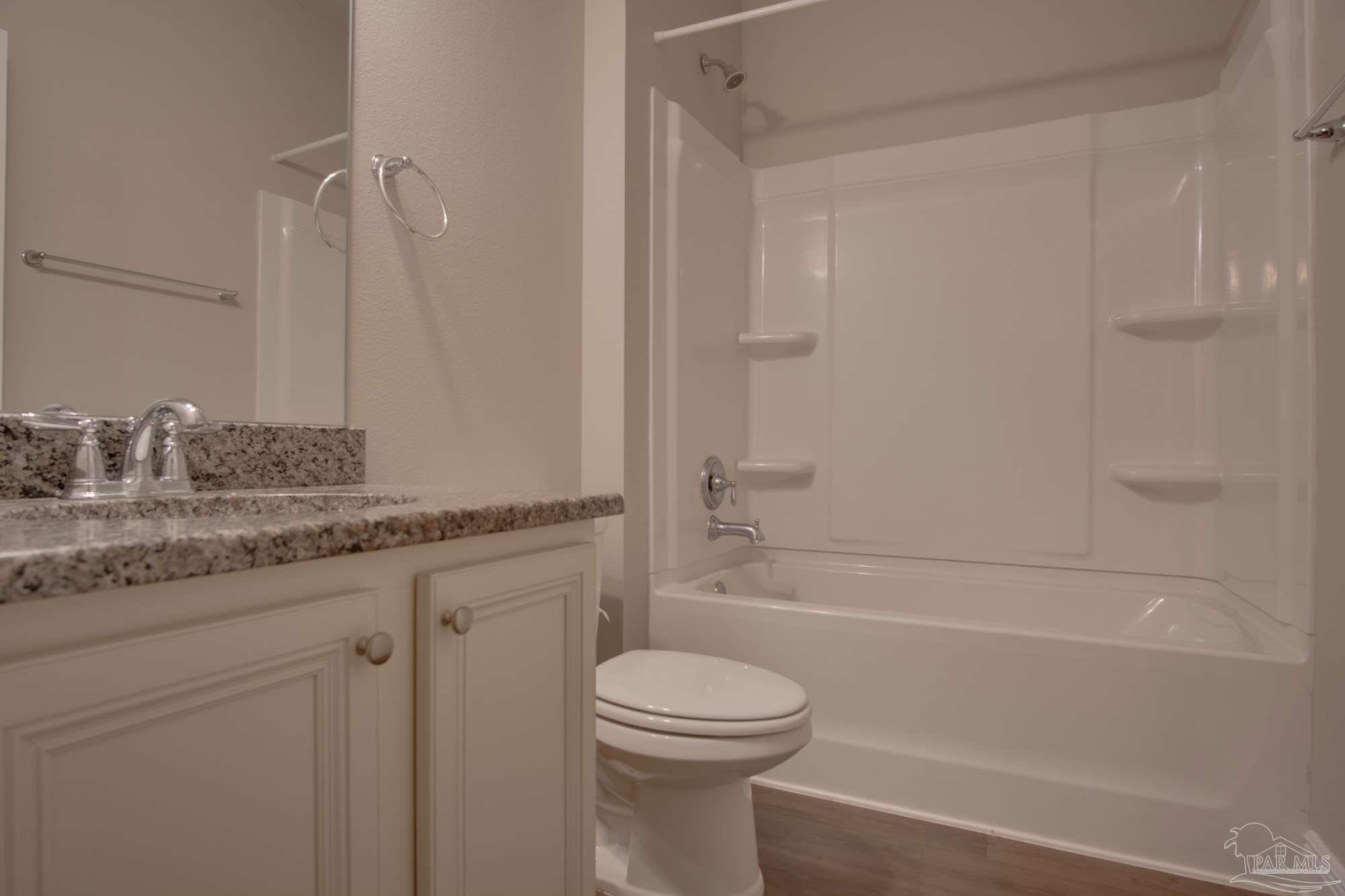 6239 Ladera Trail Pace, FL 32571 - Photo 20 of 27 a bathroom with a granite countertop sink toilet and shower