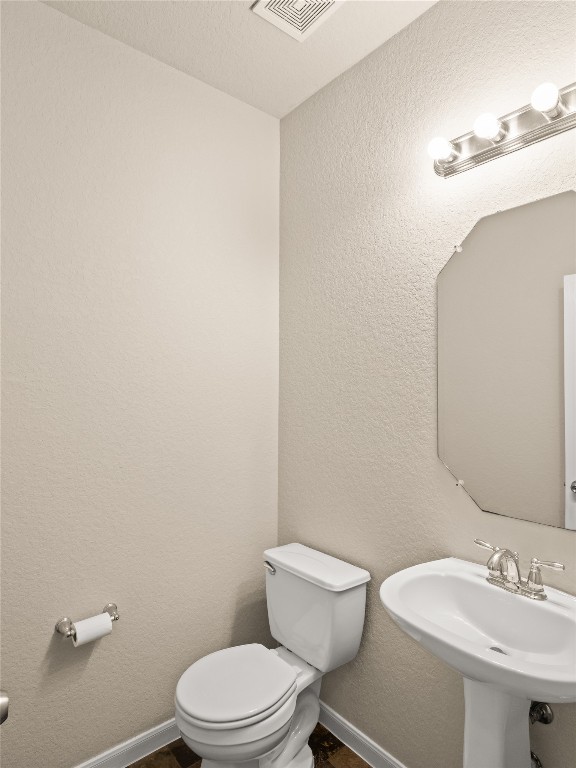 102 Wisteria Way San Marcos, TX 78666 - Photo 11 of 29 a white toilet sitting next to a bathroom sink