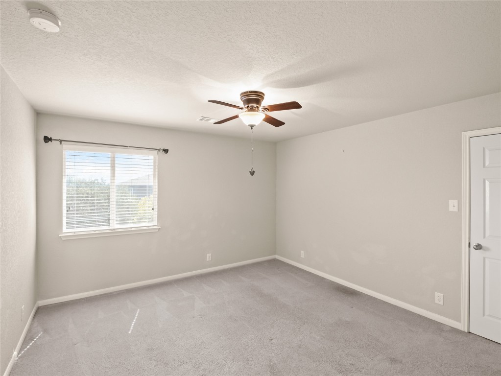 102 Wisteria Way San Marcos, TX 78666 - Photo 15 of 29 an empty room with a window and a ceiling fan