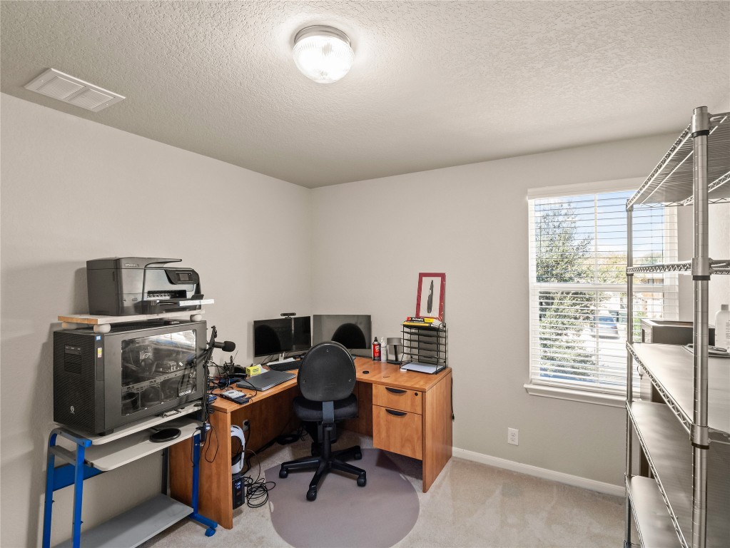 102 Wisteria Way San Marcos, TX 78666 - Photo 18 of 29 a view of a workspace with furniture and a window