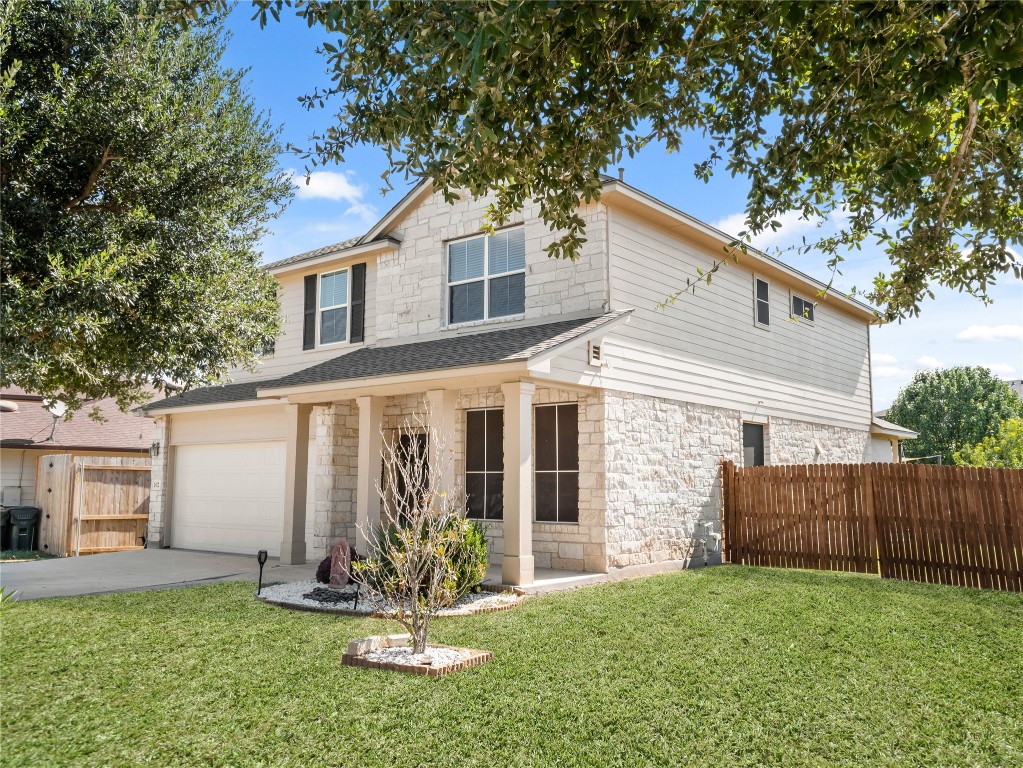 102 Wisteria Way San Marcos, TX 78666 - Photo 2 of 29 a front view of a house with a yard