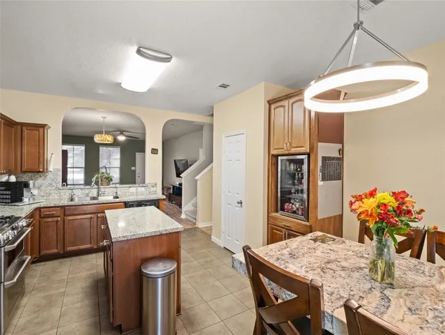 a kitchen with granite countertop a sink cabinets and stainless steel appliances