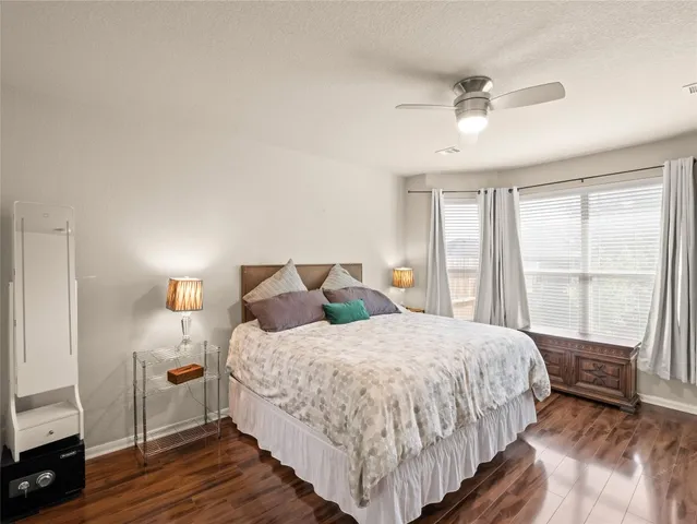 a bedroom with a large bed and a chandelier