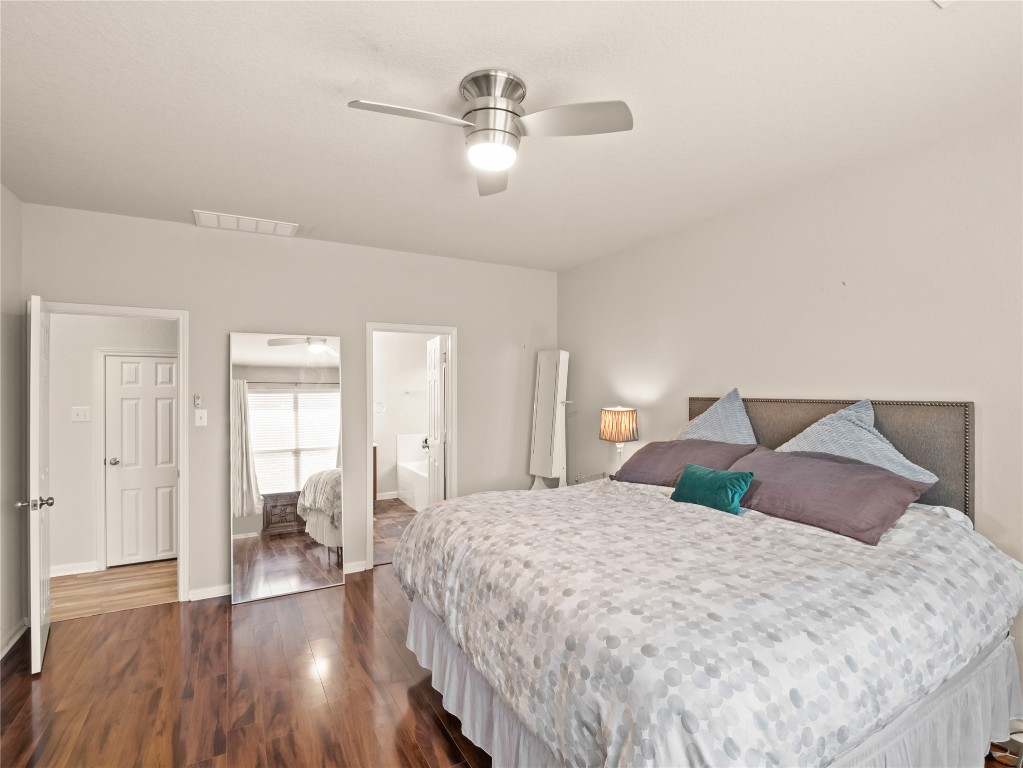 102 Wisteria Way San Marcos, TX 78666 - Photo 8 of 29 a bedroom with a large bed and a chandelier