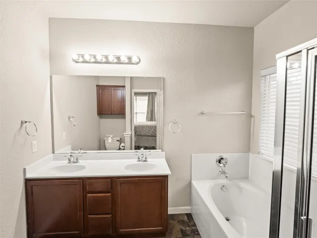 a white bath tub sitting next to a shower