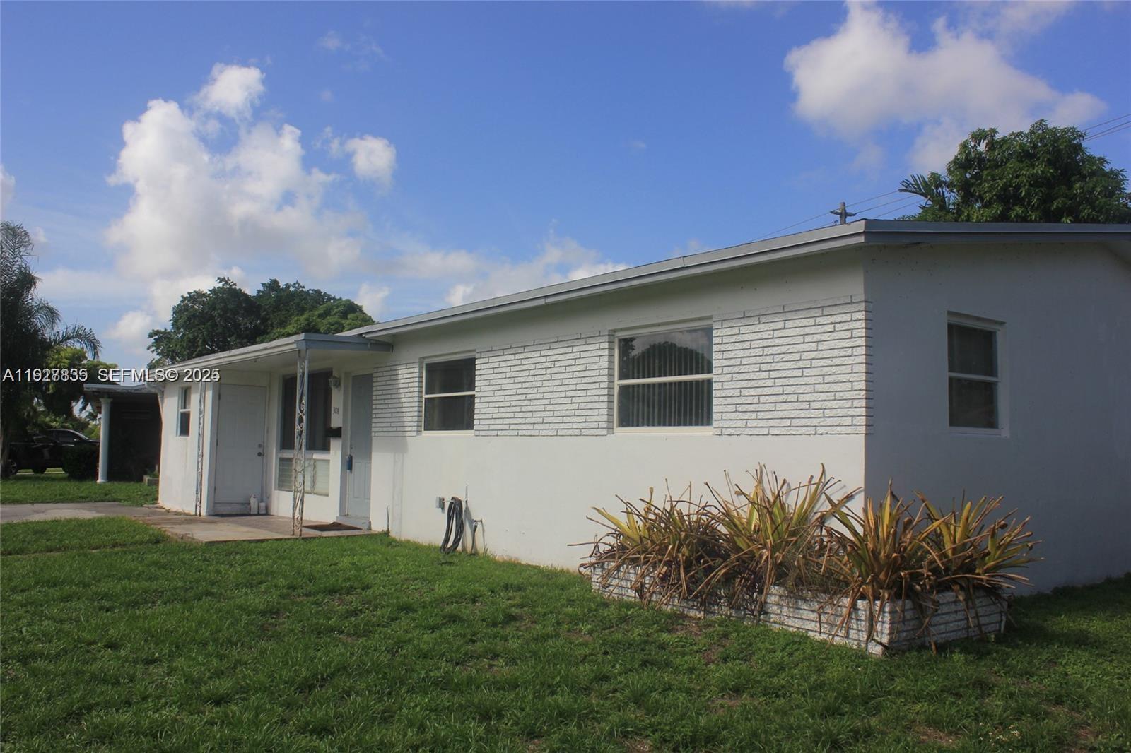 301 North 70th Avenue Hollywood, FL 33024 - Photo 1 of 14 a front view of a house with a yard
