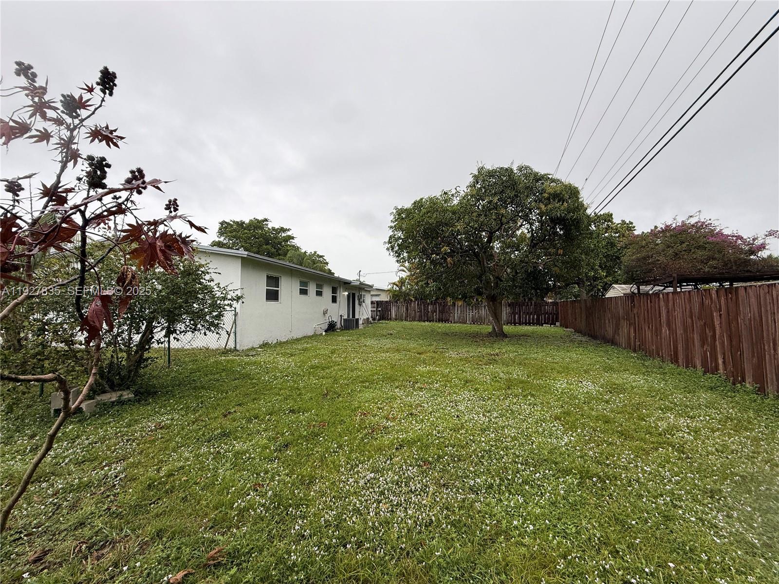 301 North 70th Avenue Hollywood, FL 33024 - Photo 14 of 14 a backyard of a house with lots of green space