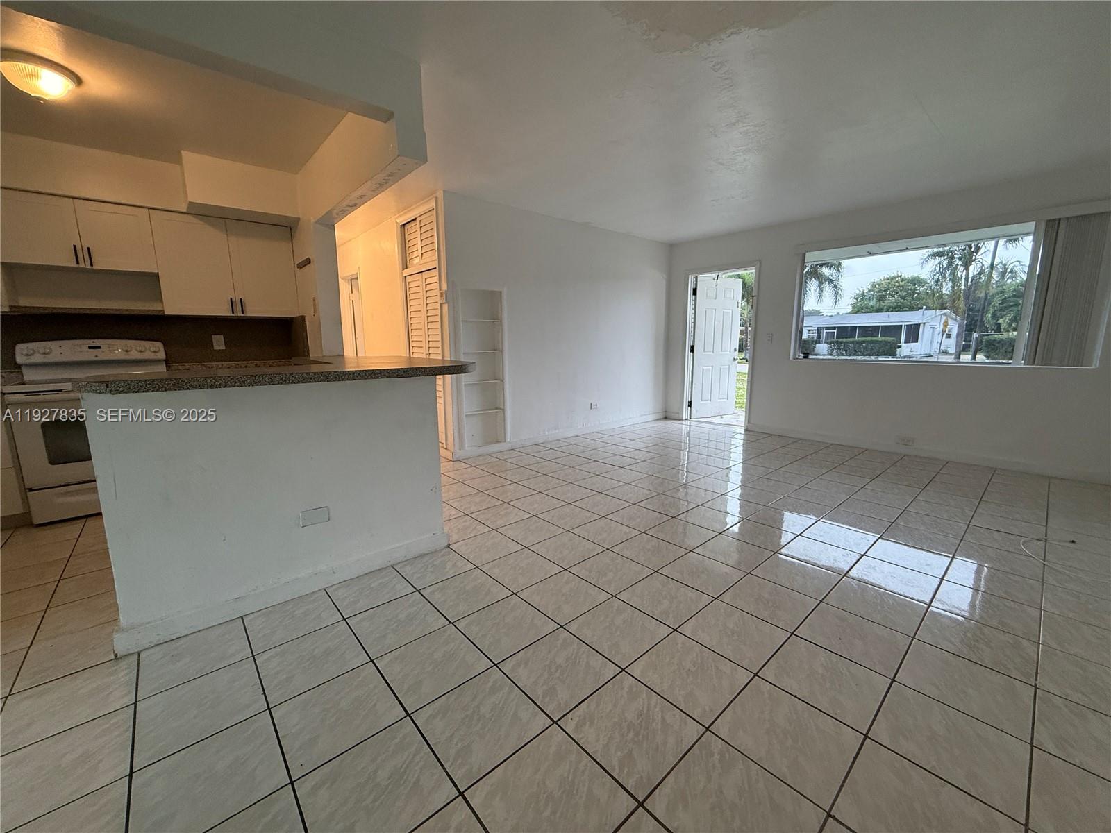 301 North 70th Avenue Hollywood, FL 33024 - Photo 4 of 14 a view of a kitchen with an empty space and a window