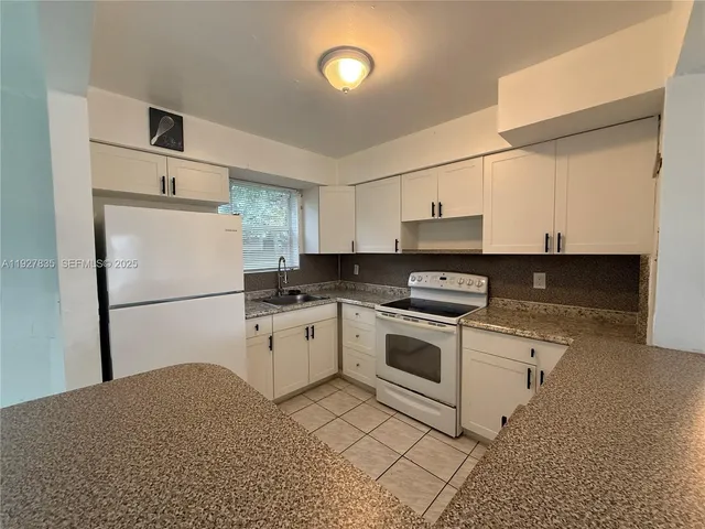 a kitchen with cabinets stainless steel appliances and a counter space